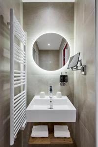 a bathroom with a white sink and a mirror at Nice Excelsior Centre ville by HappyCulture in Nice