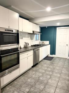 a kitchen with white appliances and blue walls at Brookswood Oasis - Guest suite,1 bedroom,1 den & 1 full bathroom in Langley