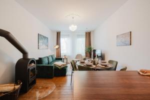 a living room with a wood stove and a couch at Altbau-Traum, Zentrumsnah, Küche, Whirlpool in Braunschweig