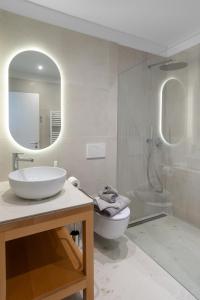 a bathroom with a sink and a toilet and a shower at Garda Dolce Vita in Torri del Benaco