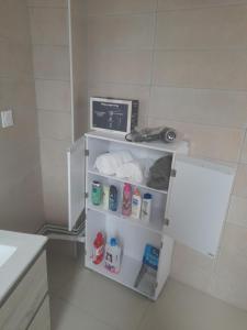 a small white refrigerator in a bathroom at S C I TREFLe in Vernon