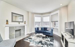 a living room with a blue couch and a fireplace at White House at Grand Central & Washington Blvd in Saint Louis