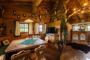 a dining room with a wooden table in a cabin at Panorama Alm Chalets by we rent JOKERCARD INCLUDED in Saalbach-Hinterglemm