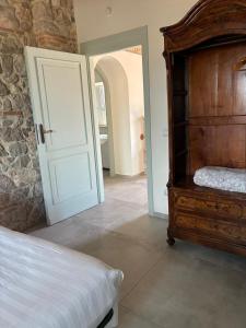 a bedroom with a bed and an open door at Fattoria solidale del Circeo in Pontinia