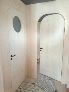 a room with a white door and a rug at Unique floating retreat Sleeps 4 in Sölvesborg