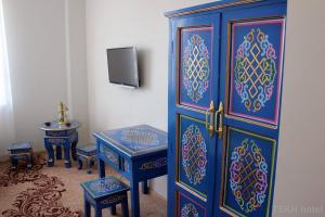 a room with a blue cabinet and two blue tables at Tsetsenkhangai Hotel in Ulaanbaatar