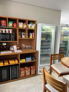 a store with a refrigerator with food in it at Vincenzo Hotel in São Vicente de Minas