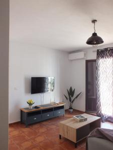 a living room with a couch and a tv at Casa Walt in Mojácar
