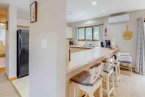a kitchen with a counter and some chairs in it at House in the Woods in Albrightsville +26 photos