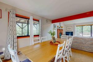 a dining room with a wooden table and chairs at House in the Woods in Albrightsville