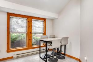 a dining room with a table and chairs and a window at House Juniper in Tannersville