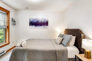 a white bedroom with a bed and a window at House Juniper in Tannersville +38 photos