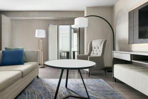 a living room with a couch and a table at Mystic Marriott Hotel and Spa in Groton