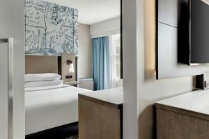 a hotel room with a bed and a window at Mystic Marriott Hotel and Spa in Groton +88 photos