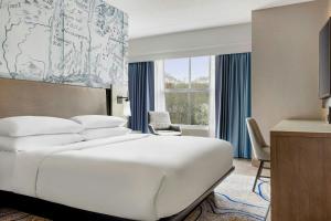 a hotel room with a bed and a desk at Mystic Marriott Hotel and Spa in Groton