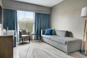 a living room with a couch and a table at Mystic Marriott Hotel and Spa in Groton