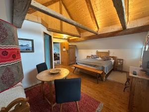 a bedroom with a bed and a table at Landlust Ischl in Bad Ischl