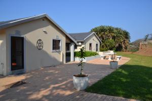 a building with a potted plant in front of it at Sea & Forest Self Catering Estate - Durban Kingsburgh in Kingsborough