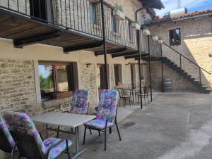 a table and chairs sitting outside of a building at Casa Vacanza in Serravalle delle Langhe