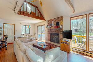 a living room with a couch and a fireplace at The Burrow in Jim Thorpe