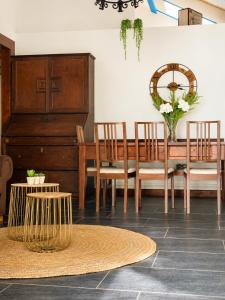 a dining room with a wooden table and chairs at Airtegal Casa do Puntal in Valdoviño