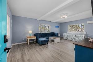 a living room with a blue couch and a table at Sanibel Sandals & Flip Flops in Sanibel