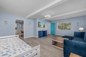 a living room with a blue couch and a table at Sanibel Sandals & Flip Flops in Sanibel