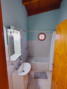 a bathroom with a sink and a bath tub at Fy Lle -Mi lugar- Gaiman in Gaiman +18 photos