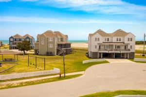 a group of houses with the ocean in the background at CAC-15B - Pollock in Buxton