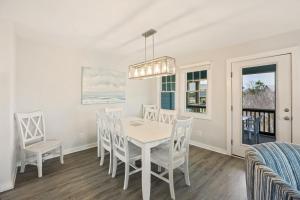 a dining room with a white table and chairs at CAC-15B - Pollock in Buxton