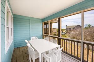 a porch with a white table and chairs on it at CAC-15B - Pollock in Buxton