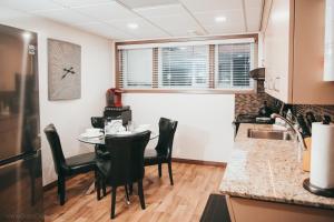 a kitchen with a table and chairs in a room at YEG Chic Luxury Accommodation in Edmonton