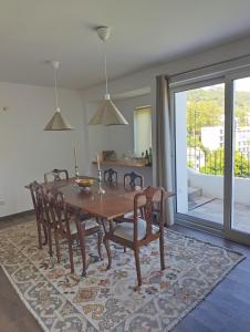 a dining room with a wooden table and chairs at Casa do Patrão Serradalto in Manteigas