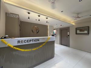 a reception area of a hospital with a yellow rope at Hotel Prime Divine in Ahmedabad