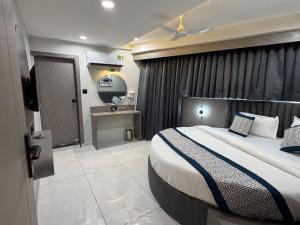 a hotel room with a bed and a mirror at Hotel Prime Divine in Ahmedabad