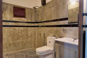 a bathroom with a shower and a toilet and a sink at Nil Nadiya Holiday Resort in Matara +22 photos