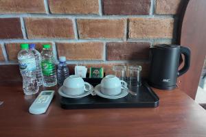 a tray with cups and plates and a coffee maker on a table at Nil Nadiya Holiday Resort in Matara