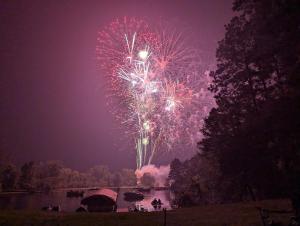 a firework display over a body of water at night at 2BR 1BA Cabin #8 at Riverside Point Resort in Park Rapids
