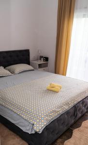 a bedroom with a bed with a yellow towel on it at Villa Mali Raj in Čapljina +33 photos