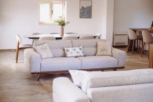 a living room with a couch and a table at Heritage House Strahinja Stone Villa with Private Pool in Popovići