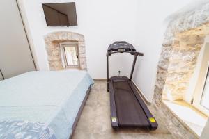 a bedroom with a bed and a stone wall at Heritage House Strahinja Stone Villa with Private Pool in Popovići +82 photos