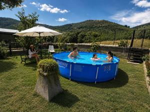 a group of people in a hot tub in a yard at Il Posto delle Rose 1 in San Polo dei Cavalieri