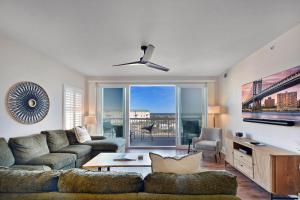 a living room with a couch and a large window at St. Simons Grand 307 in Saint Simons Island