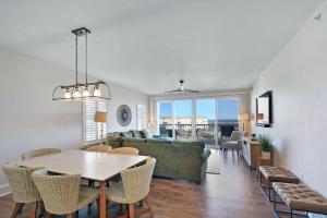 a living room with a table and a couch at St. Simons Grand 307 in Saint Simons Island