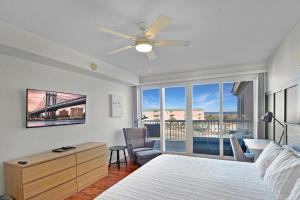 a bedroom with a bed and a view of a bridge at St. Simons Grand 307 in Saint Simons Island +31 photos