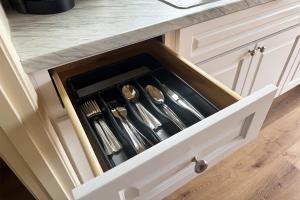 a drawer in a kitchen with utensils in it at Old Faithful RV Park LLC in Cody