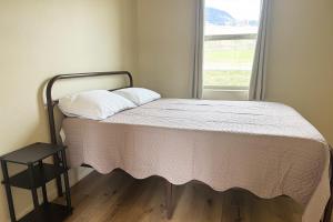 a bed in a room with a window at Old Faithful RV Park LLC in Cody
