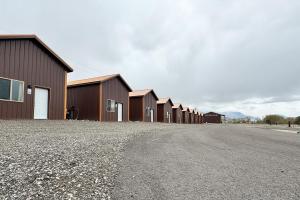 a row of buildings on the side of a road at Old Faithful RV Park LLC in Cody