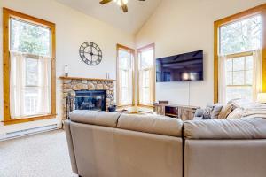 a living room with a couch and a fireplace at Casa Lontano in Tannersville