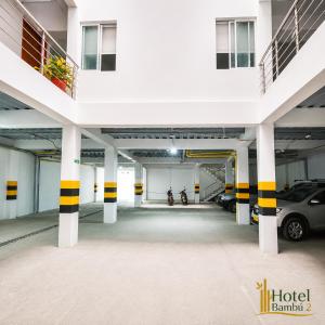 a large parking garage with cars parked in it at Hotel Bambù 2 in Puerto Asís
